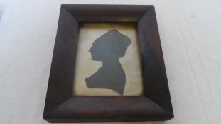 AN ANTIQUE SILHOUETTE OF A GENTLEMAN BLACK INK ON PAPER, OVAL IN A BLACK FRAME TOGETHER WITH A BLACK