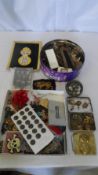 A LARGE COLLECTION OF MILITARIA BADGES, BUTTONS ETC...