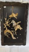 AN ANTIQUE HARDWOOD PANEL IN THE ORIENTAL STYLE DEPICTING GEESE IN FLIGHT WITH POSSIBLY IVORY AND