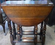 AN OVAL OAK DROP LEAF TABLE ON TURNED LEGS WITH STRETCHERS, APPROX. 90 X 68 X 74 cms