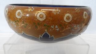 A ROYAL DOULTON FRUIT BOWL WITH ROYAL BLUE INTERIOR AND GILDED FLORAL DESIGN TO THE EXTERIOR.