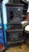 AN EDWARDIAN ORNATELY DECORATED DARK OAK CORNER CABINET ON BALL AND CLAW FEET, THE DOOR TO THE TOP