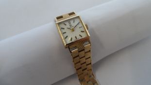 A LADY`S OMEGA 9ct YELLOW GOLD VINTAGE WRIST WATCH ON 9 ct GOLD ENGINE TURNED BLOCK LINK BRACELET,