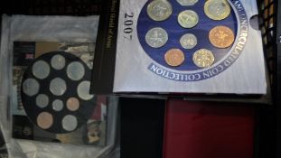 A BOX CONTAINING TWENTY TWO COMMEMORATIVE CROWNS AND VARIOUS OTHER COINS AND NOTES