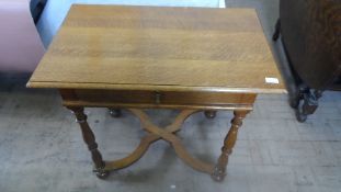 A GOLDEN OAK HALL TABLE FITTED WITH A SINGLE DRAWER ON TURNED LEGS AND SHAPED STRETCHERS, APPROX. 81