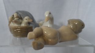 A LLADRO FIGURE OF A MOTHER DUCK AND HER DUCKLINGS TOGETHER WITH A SLEEPING CHERUB. (2)