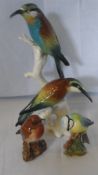 TWO BESWICK FIGURES OF BLUE TIT AND THE ROBIN TOGETHER WITH A GERMAN FIGURE OF HONEY BIRDS SEATED ON