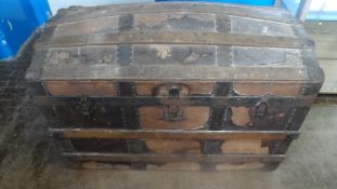 A VINTAGE LEATHER AND WOOD DOMED CHEST HAVING METAL BANDING