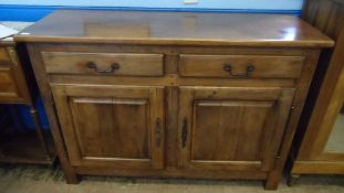 A WESLEY-BARRELL `CHATEAU` TWO DOOR SIDEBOARD HAVING TWO DRAWERS AND CUPBOARDS BELOW ENCLOSING A