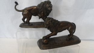 AN ANTIQUE BRONZED FIGURE OF A LION FIGHTING A SNAKE 21 x 10 x 14 cms TOGETHER WITH ANOTHER