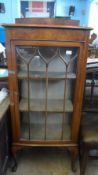 A VICTORIAN WALNUT GLAZED FRONT DISPLAY CABINET HAVING THREE SHELVES TO THE INTERIOR ON CABRIOLE