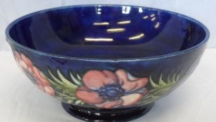AN A W. MOORCROFT FRUIT BOWL OF ANEMONE DESIGN - 10 cms HEIGHT X 24 cms DIAMETER. SIGNED IN GREEN TO