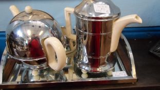 A VINTAGE ART DECO `EVERHOT` TEA SET COMPRISING TEA POT, COFFEE POT, SUGAR BOWL AND MILK JUG ON AN