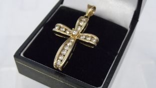 A 9CT HALLMARKED CROSS SET WITH DIAMONDS, APPROX. 5.4 gms TOTAL WEIGHT. APPROX. 80pts