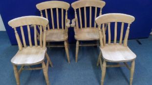 A SET OF SIX PINE SPINDLE BACK DINING CHAIRS ( INCLUDES TWO CARVERS )