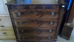 A VICTORIAN SHAPED FRONT FLAME MAHOGANY CHEST OF DRAWERS ON BUN FEET - FOUR LONG DRAWERS HAVING