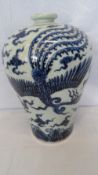 A LARGE BLUE AND WHITE BALUSTER VASE DEPICTING A PHOENIX AND DRAGON IN FLIGHT AMONGST THE CLOUDS. 42