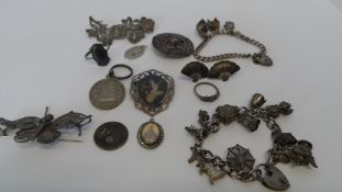 A COLLECTION OF MISC. SILVER AND SILVER METAL JEWELLERY INCL. TWO CHARM BRACELETS, ARTS AND CRAFTS