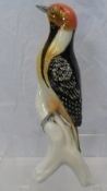 A PORCELAIN FIGURE OF A WOODPECKER IMPRESSED 7631 TO BASE, APPROX. 24 cms