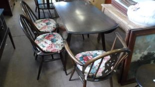 A DARK OAK STYLE ERCOL OVAL DROP LEAF TABLE AND FOUR CHAIRS ONE BEING A CARVER.