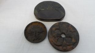 A CHINESE IRON TSUBA - EROTIC SCENES CARVED IN RELIEF WITH DISH 6.5 cms TOGETHER WITH A STONE DISC