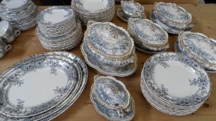 A PART VICTORIAN STERLING K & CO. POTTERY DINNER SERVICE DEPICTING FLOWERS WITH GILDED BORDER IN