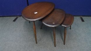 A NEST OF THREE ERCOL KIDNEY SHAPED TABLES TOGETHER WITH A COFFEE TABLE. (4)