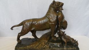 CAIN AUGUSTE-NICOLAS ( FRENCH 1821-1894 ) - AN IMPRESSIVE BRONZE STUDY OF A LIONESS PRESENTING A