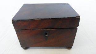 AN ANTIQUE MAHOGANY BOX ON BALL FEET.