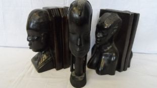 A COLLECTION OF AFRICAN WOOD CARVINGS INCLUDING TWO PAIRS OF HARD WOOD BOOK ENDS DEPICTING AFRICAN