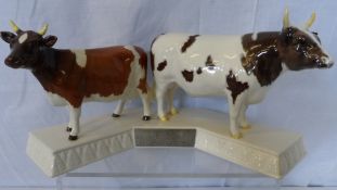 A BESWICK STUDY OF AN AYRSHIRE BULL `WHITEHILL MANDATE` AND A COW ‘ICKHAM BESSIE’ ON A PORCELAIN
