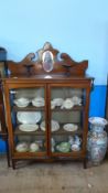 AN ANTIQUE DISPLAY CABINET WITH GLASS FRONTED DOORS AND TWO ORNAMENT STANDS TO TOP, APPROX. 105 X