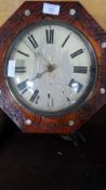 A VINTAGE WALL HANGING CLOCK WITH WOOD AND BRASS MOVEMENT AND TWO PENDULUMS, THE SURROUND BEING