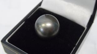 A LARGE BLACK PEARL, NOT TESTED