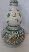 A CHINESE DOUBLE GOURD VASE DEPICTING PHOENIX IN FLIGHT AND A FLORAL HEAD DESIGN TO RIBBED PANELS,