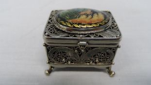 A RUSSIAN SILVER METAL MINIATURE BOX WITH HAND PAINTED PORCELAIN CAMEO TO THE TOP DEPICTING DEER,