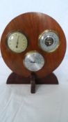 AN OAK BAROMETER TOGETHER WITH A BAROMETER STATION INCLUDING A HYGROMETER.