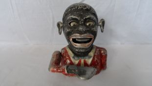 A METAL MONEY BOX IN THE FORM OF A BLACK MUSICIAN, STARKIES PATENT