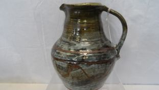 AN ARTS AND CRAFTS STUDIO POTTERY WATER JUG, APPROX. 22 cms WITH IMPRESSED MARKS TO BASE