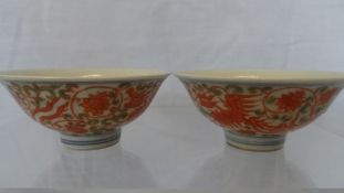 A PAIR OF CHINESE PORCELAIN BOWLS DEPICTING RED PHOENIX IN FLIGHT WITH CHRYSANTHEMUM AND SCROLL LEAF