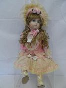 A COPY OF A KAMMER & REINHARDT  14 " 1987 PORCELAIN DOLL - WITH HAND PAINTED FACE WITH FIXED BLUE