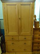 AN ANTIQUE PINE TALLBOY HAVING ENCLOSED SHELVES TO THE TOP WITH TWO SHORT AND TWO LONG DRAWERS BELOW