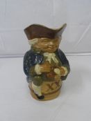 A ROYAL DOULTON LAMBETH STONEWARE TOBY JUG DESIGNED BY HARRY SIMEON DEPICTING A PORTLY GENTLEMAN