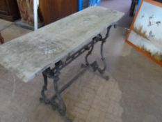 A VINTAGE CAST IRON PUB TABLE WITH SINGLE TIE BAR TO CENTRE HAVING A RUSTIC WOODEN TOP, APPROX.