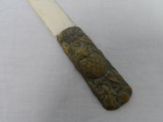 A ORIENTAL IVORY PAPER KNIFE HAVING BRASS AND COPPER HANDLE DEPICTING AN OWL AND FLOWERS TO ONE SIDE