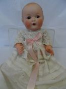 AN ARMAND AND MARSEILLE PORCELAIN DOLL - A HAND PAINTED FACE WITH SLEEPING EYES AND OPEN MOUTH