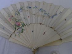 A CIRCA 1890 IVORY AND SATIN SILK FAN. THE MOUNT HAVING PAINTED FLOWERS AND INSECTS. THE IVORY