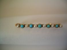 AN EDWARDIAN GOLD SEED PEARL AND TURQUOISE PIN BROOCH
