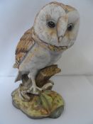 A BISQUE CONTINENTAL FIGURE OF A BARN OWL BY MARMI WITH IMPRESSED MARK R TO THE BASE, APPROX. 14 CM