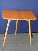 A VINTAGE ERCOL THREE LEGGED OCCASIONAL TABLE.